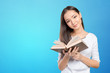 © fotofabrika - Woman university / college student holding book