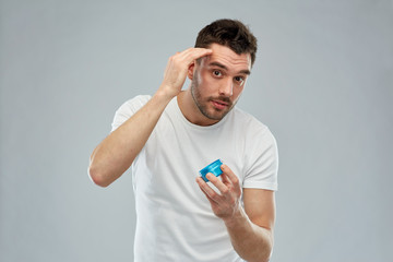 Poster - happy young man styling his hair with wax or gel