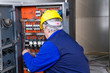 © franco lucato - electrician at work with an electric panel