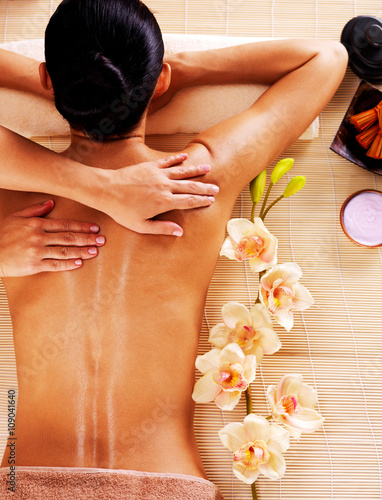 Naklejka dekoracyjna Adult woman in spa salon having body massage.