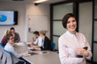 © .shock - hispanic businesswoman with tablet at meeting room