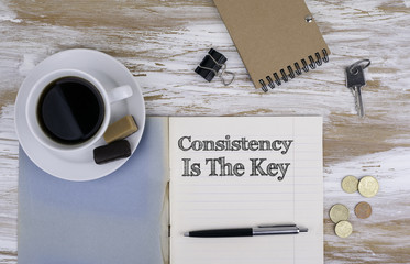 Consistency is The Key - Copybook on the desktop.