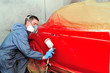 Painting red car.