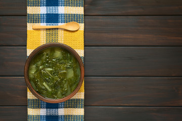 Poster - Chard soup photographed on dark wood with natural light