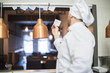 © gpointstudio - Rear view of chef taking orders