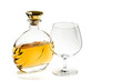 Bottle of brandy and empty snifter on white background