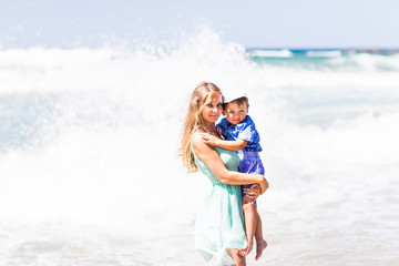 Portrait of happy mother and son at sea, outdoor