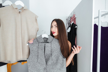 Wall Mural - Woman choosing cloth in store