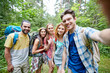 © Syda Productions - friends with backpack taking selfie in wood