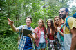 © Syda Productions - happy friends with backpacks and tablet pc hiking