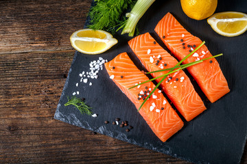 Salmon filet sliced on three parts with lime and herbs.