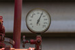 Water pressure meter installed on a red pipe