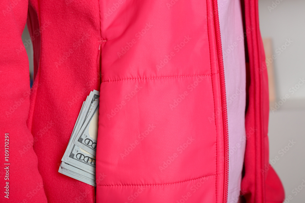 Cash in the red jacket pocket, close up