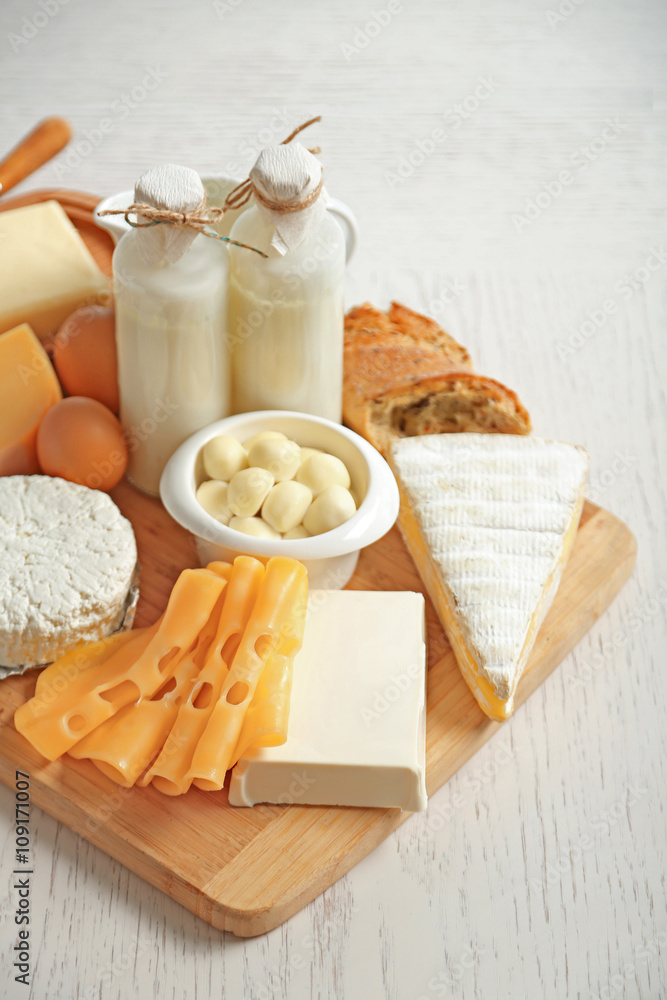 Set of fresh dairy products on white wooden table