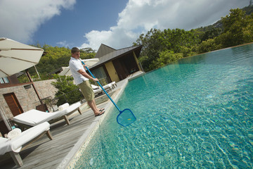 Wall Mural - Swimming pool cleaner, professional cleaning service at work.