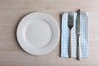 © Africa Studio - Empty plate with silver fork and knife on wooden background
