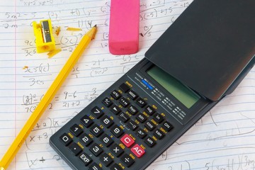 Math Homework Algebra:
A macro picture of Math College Algebra homework paper and math accessories.