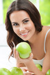 © vgstudio - Young smiling woman with green apples