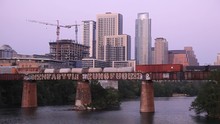Freight Train Wagons On A Bridge Over The Colorado River In Austin City. Texas, USA
