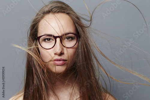 Fotografia, Obraz Beautiful brunette in spectacles with windswept hair