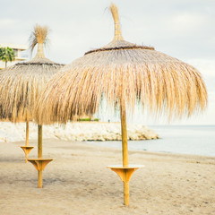 Several straw sunshade on beach