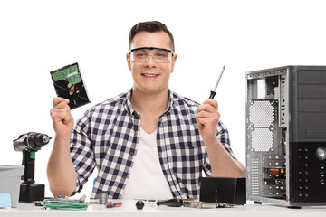 Poster - Male PC technician holding a computer part