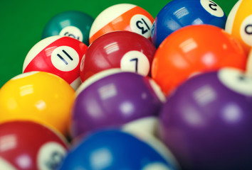 Wall Mural - billiard balls on a green pool table, closeup