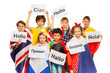 © Sergey Novikov - Kids holding greeting signs in different languages