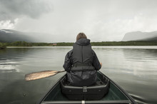 Rear View Of Woman Kayaking In Lake