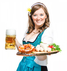 Wall Mural - Fröhliche Frau mit Bierkrug und Bayerischen Spezialitäten (Oktoberfest)