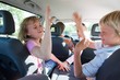 © Connect Images - Children fighting in back seat of vehicle on road trip