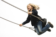 Little Child Blond Girl Having Fun On A Swing Outdoor. Summer Playground. Girl Swinging High 