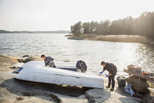 Men Painting Boat Near Lake