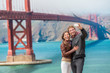 © Maridav - Happy young couple tourists taking selfie in San Francisco by Golden Gate Bridge. Interracial young modern couple using smart phone. Asian woman, Caucasian man.