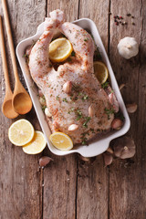 Wall Mural - raw chicken marinated with garlic, herbs, spices and lemon. vertical top view
