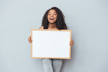 Cheerful Afro American Woman Showing Blank Board