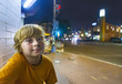 © travelview - cute boy smiles tired while sitting outside by night