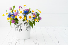 Beautiful Bouquet Of Bright Wildflowers In Basket Over Old Rustic Table. Mothers Day Greeting Card Concept