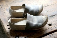 Two Old Dutch Style Wooden Clogs In The Workshop Of A Shoemaker