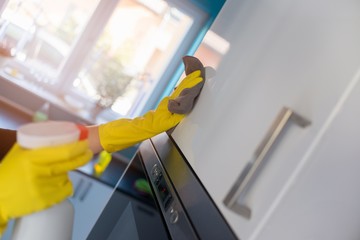 Wall Mural - woman's hands cleaning kitchen cabinets