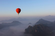 © ketklao - Red Hot-air Balloon float over Misty Mountain in Vang Vieng, Lao