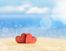 Two Red Hearts On The Sandy Beach
