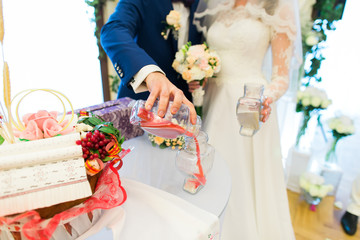 The bride and groom perform ritual ceremony of sand 