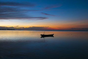 Wall Mural - Sunset with fisher boat and still water on Gili Air Island, Indo