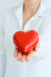 © adrian_ilie825 - Woman holding and protecting a red heart shape