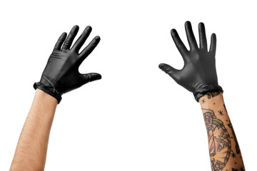 Man's hands with tattoo in black latex gloves