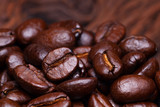 Roasted detailed tasty coffee beans with natural blurry background.