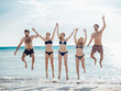 © juripozzi - group of people jumping at beach