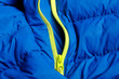 blue down jacket with green zipper pocket