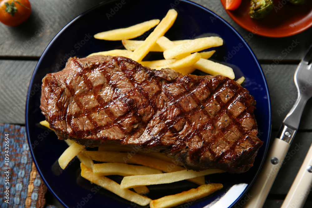 Grilled steak with french fries, closeup